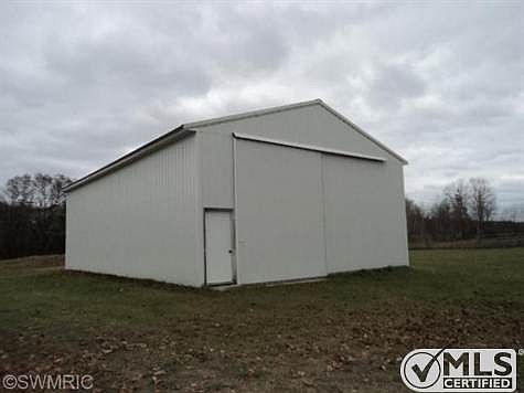 This motor home storage size barn is 32' x 48' with 1/2 cement floor. sliding doors in front and back. One of 5 outbuildings.
