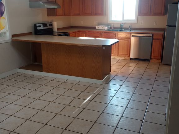 Kitchen/dining (shown vacant and with current stainless appliances)