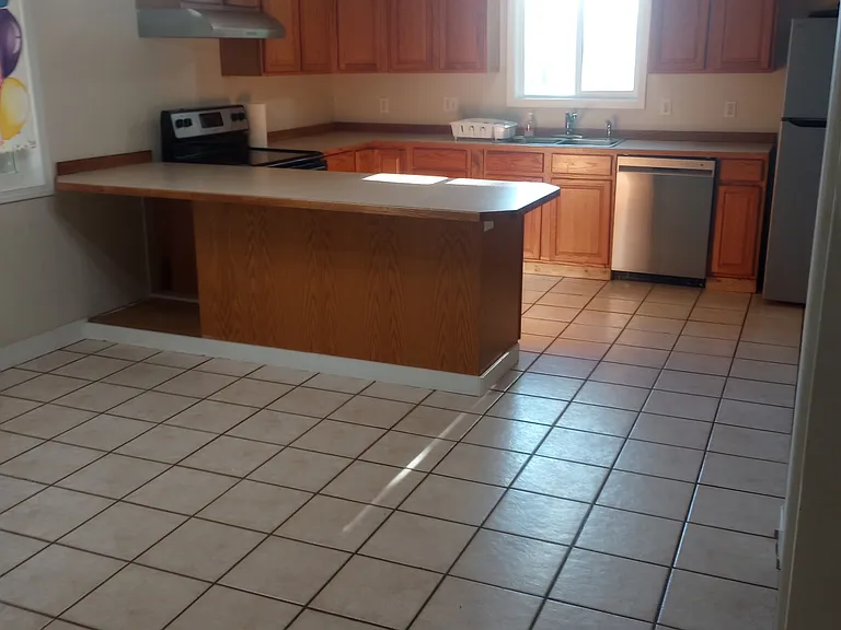 Kitchen/dining (shown vacant and with current stainless appliances)