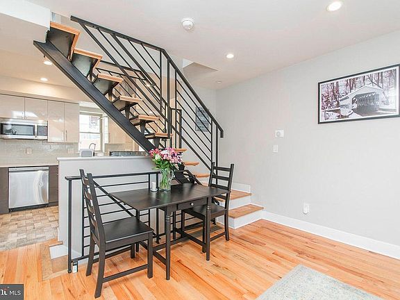 looking into the living/dining room, kitchen and central stair case