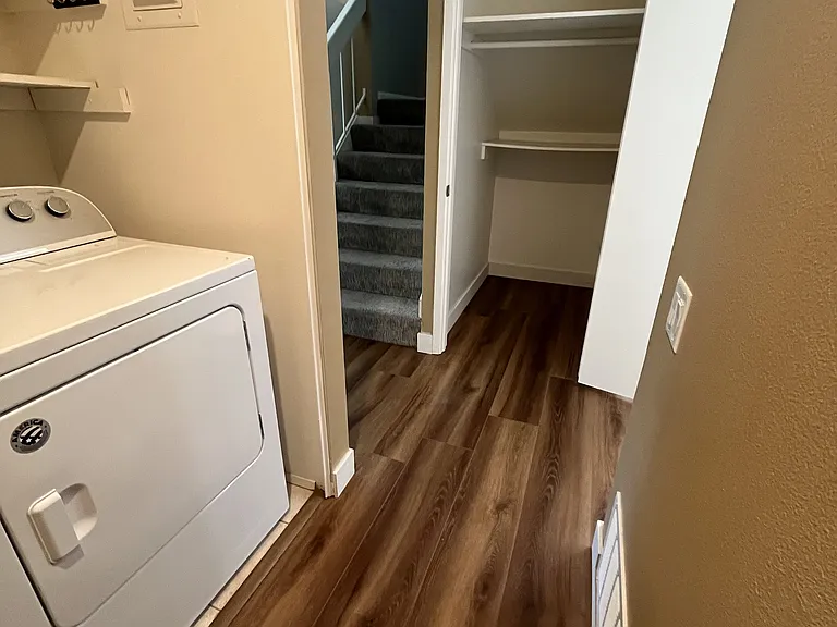 Hallway from 1/2 Bath to closet beneath the stairs.