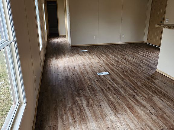View from entry way to living room and second, third bedrooms and second bath.