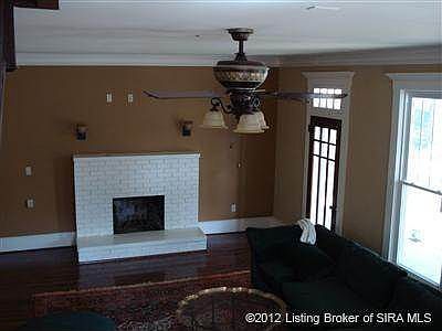 Living Room has crown molding and hardwood flooring.