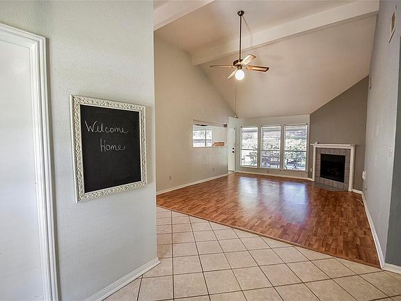 The family room and formal dining room have lovely wood laminate flooring, and take a look at that corner gas-log fireplace - very nice for cozy evenings in the winter and a nice focal point year-round! The door to the left leads to the garage and th
