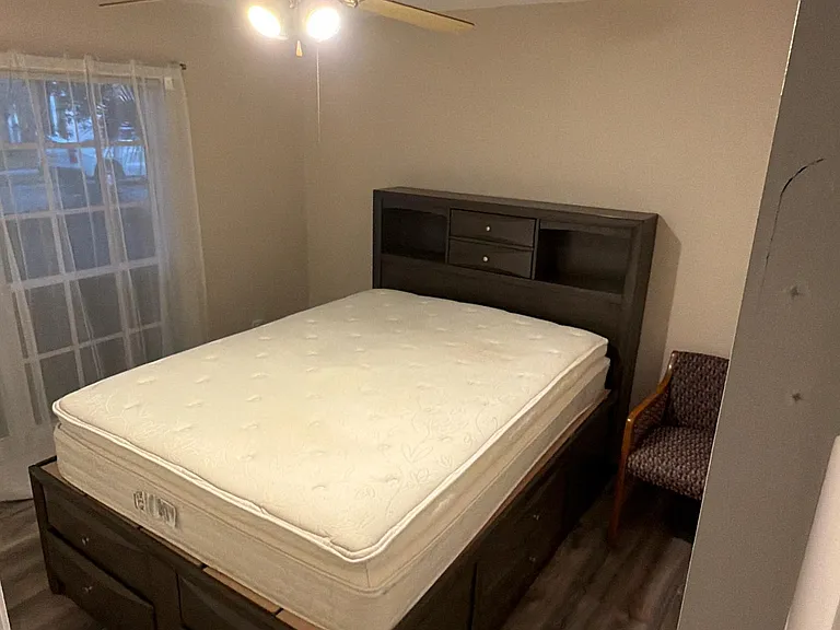 Bedroom #3 with Queen Size bed, large window and closet with built in shelving units.