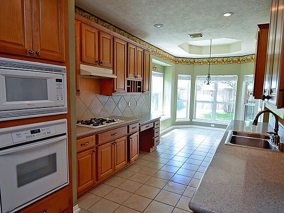 A very spacious kitchen with tons of cabinet and counter top space.
