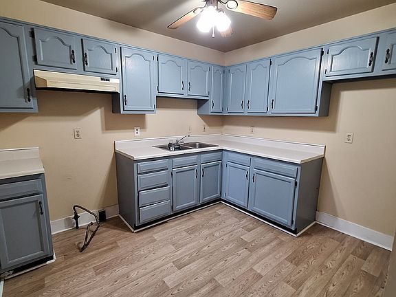 Kitchen with refinished cabinets and new flooring