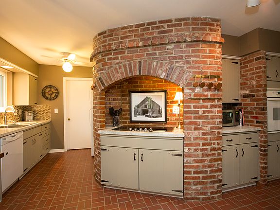 Loaded with charm, the spacious Kitchen boasts new SS sink & brushed nickel single arm faucet, glass tile backsplash and custom antiqued barn door hardware enhancing the cottage door cabinets.