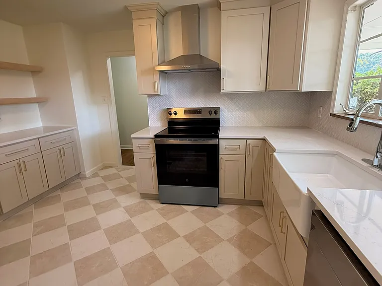 Completely renovated kitchen with new custom cabinets, farmhouse sink, new stainless steel appliances.