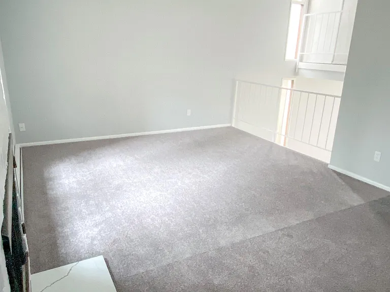 living room- view from exterior door that leads to the fenced in backyard