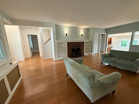 Part of main floor (entry on left, primary bedroom straight ahead, stairs, living room, dining & kitchen on right, family room is behind/off the living room)