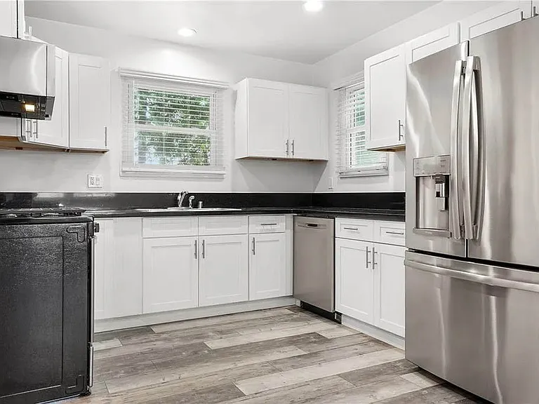 Beautifully updated kitchen with white shaker cabinetry, granite counters, brushed nickel pulls and handels, stainless appliances and more