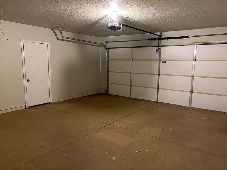 View of garage with new garage door and motor.