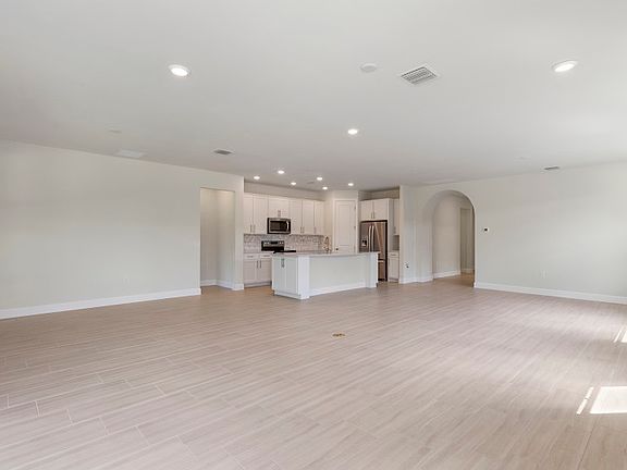 Spacious floor plan with LED lighting and tile floors in main living rooms