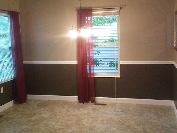 Dining area off the kitchen. Garden view from windows. Back door on left leads to private parking spots.