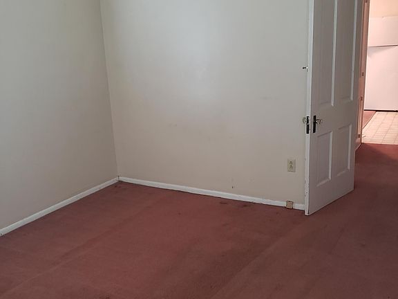 Bedroom showing door off kitchen