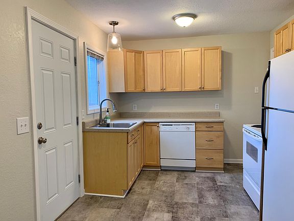 Kitchen with access to rear yard through door on left. New vinyl flooring