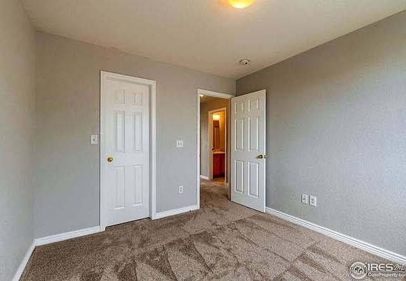 The door on the left opens to a walk-in closet.
