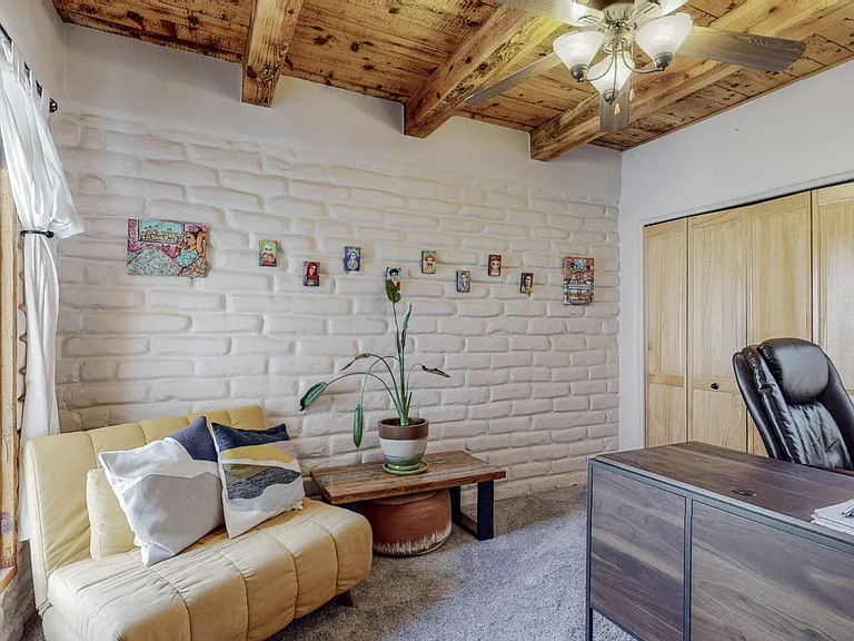 Bedroom 3, currently dedicated office space with chair that rolls-out into a single bed