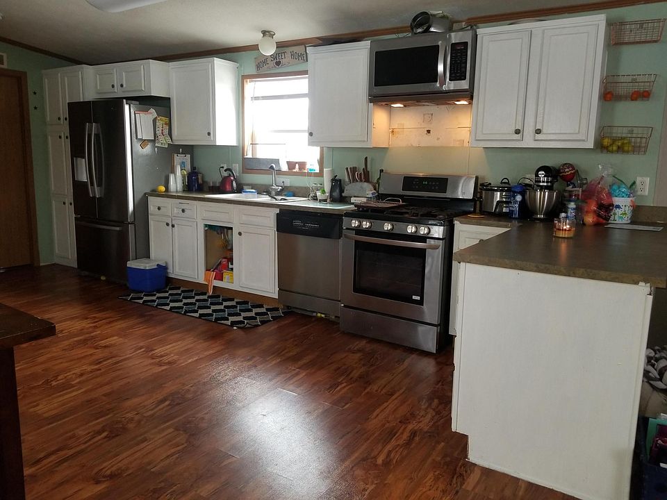 Kitchen, flooring has been updated to match living room flooring.