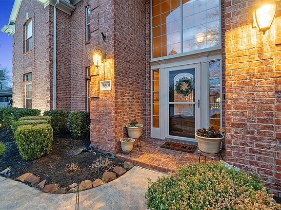Beautiful brick exterior and lovely walkway leading to the covered porch.