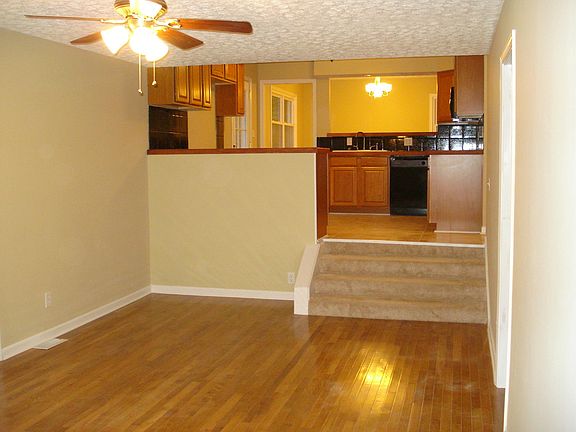 Family room with steps leading up to kitchen