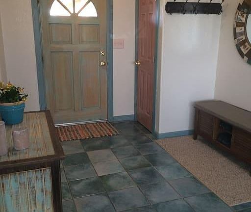 Inside front door, with coat rack and shoe bench