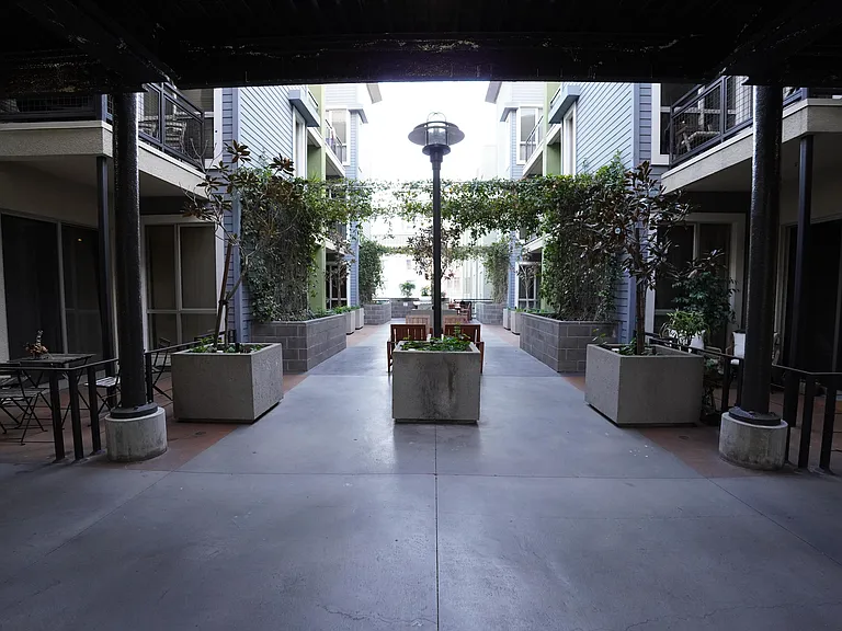 shared patio area with grill and propane tank towards the back