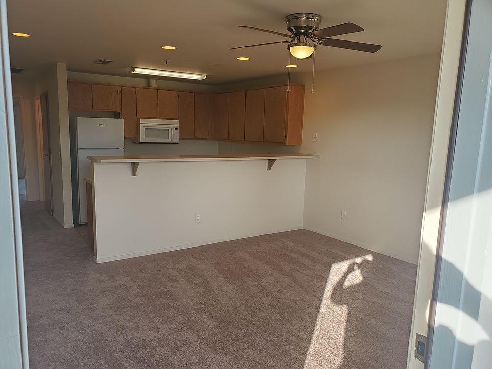 The front door leads to the living room with fan.