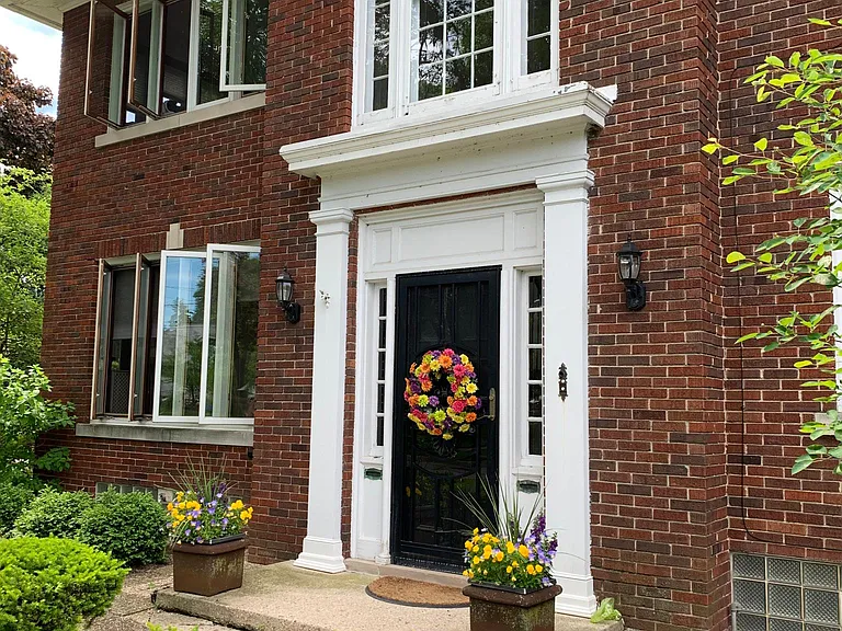 Front door, palladian window and sunroom to the east.