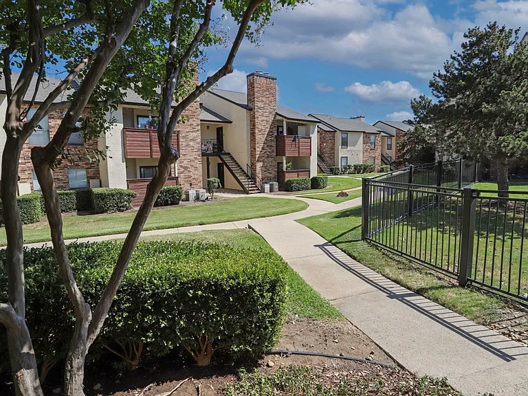Classic apartment community with open green spaces and mature landscaping