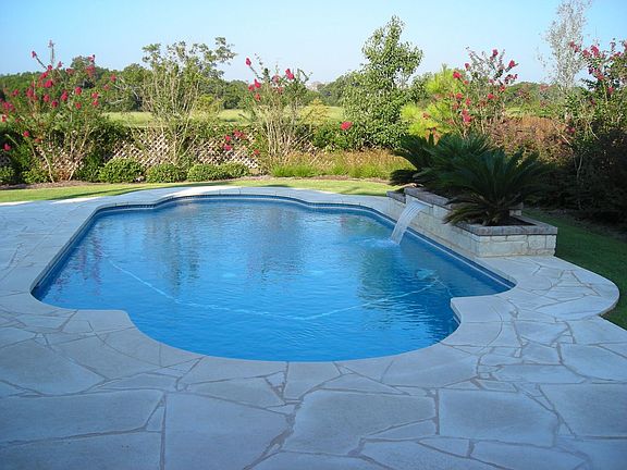 Pool with back yard landscape