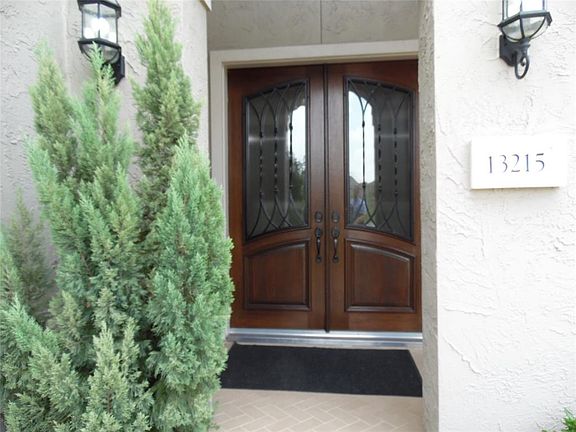 The double door 8 feet obscured glass with wrought iron accents guides you to the striking 20 foot ceiling, grand staircase and marvelous dining area.