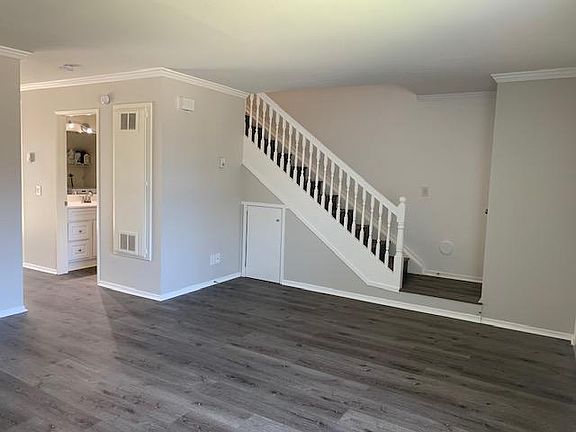 Living Room View to Stairs/Storage