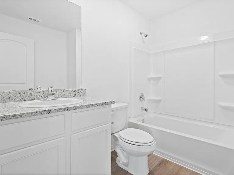 The second bathroom with granite countertops.