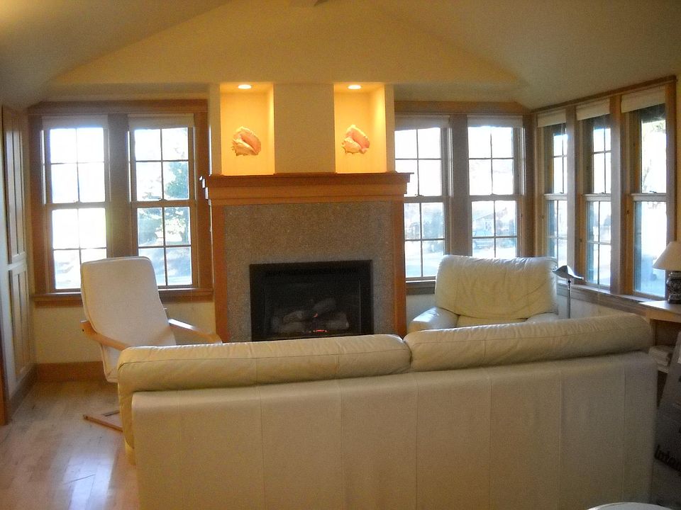 Gas fireplace with granite facing, light display shelves and