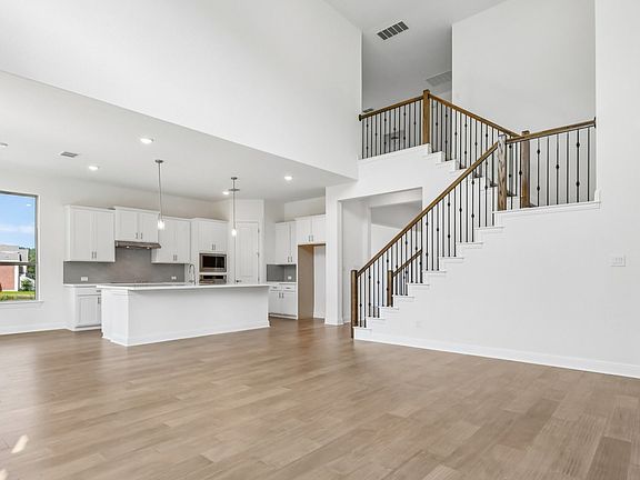 An interior shot of the living room kitchen in the Brown floorplan at Retreat at San Gabriel - Repre