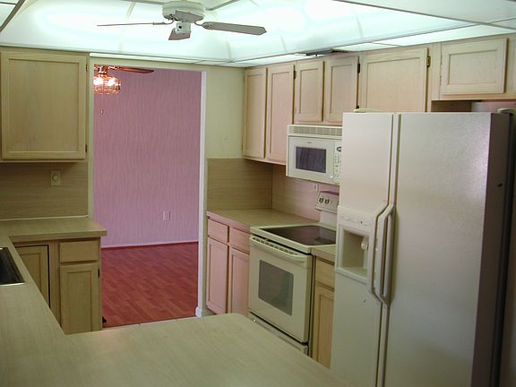 Updated kitchen with neutral wood cabinets and newer appliances