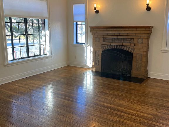 Living room. Hardwood floors and cozy fireplace. Fan's are in LR, kitchen, and both bedrooms. A swamp cooler - not shown - is in window to the right of fireplace.