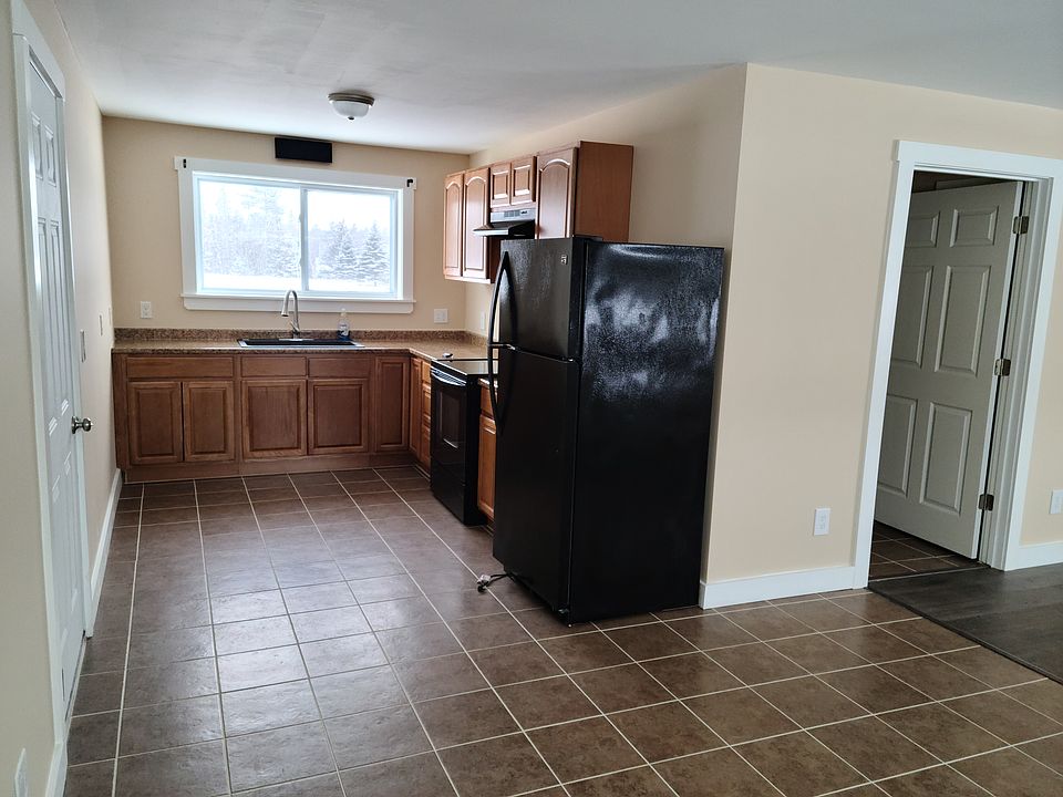Looking into kitchen from dining area. 
Door to garage on left
Door to bathroom on right