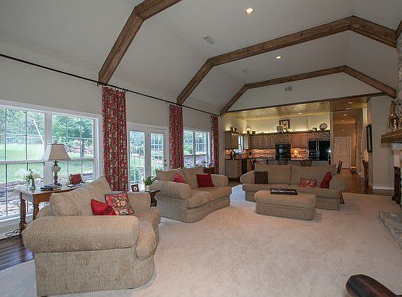 Great room features wood beam detail