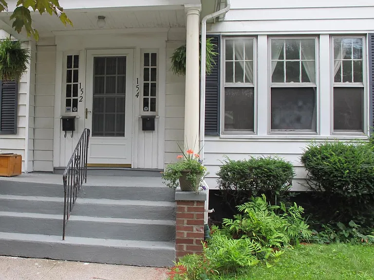Front of House with Townhouse on the Right Side of Home.