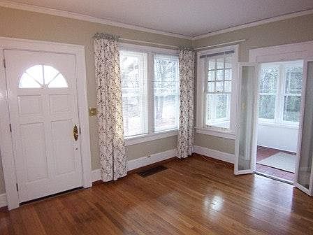 Livingroom facing East with natural light and midtown skyline view. Attached sunroom with side entrance can be office or garden room.