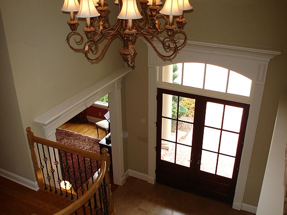 Stunning two-story foyer with inlaid marble flooring & grand chandelier