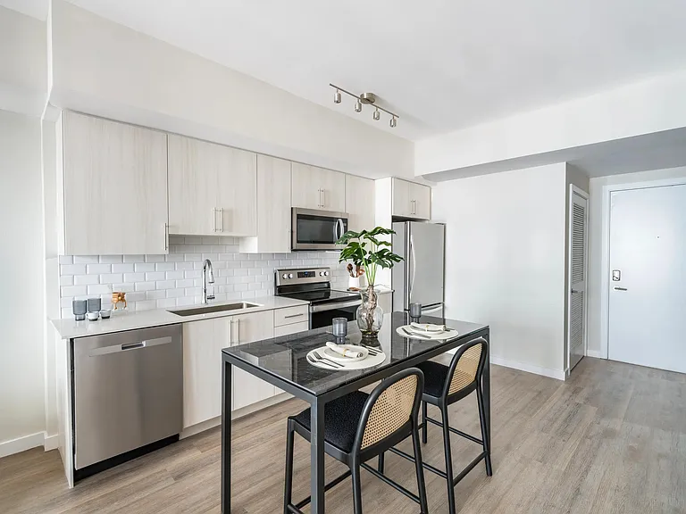Cook in style with gourmet kitchens featuring quartz countertops and 36-inch custom cabinetry.