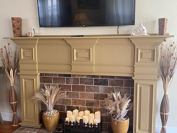 60" smart TV over decorative fireplace
