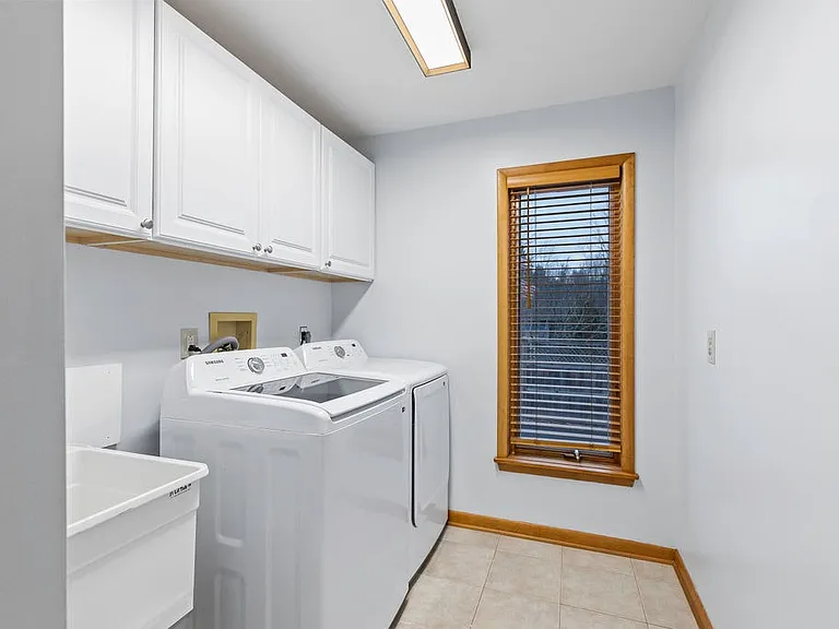 Laundry room with new appliances and storage