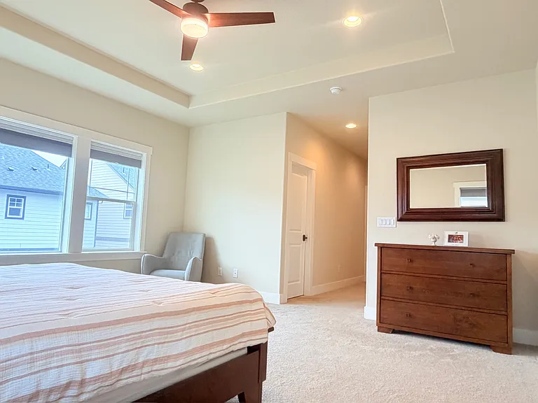 Master bedroom with ceiling fan.
Top_down bottom_up cellular shades: daylight above, blackout below