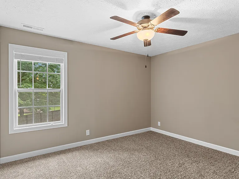 Bedroom 2 looks out on the private, fenced in backyard