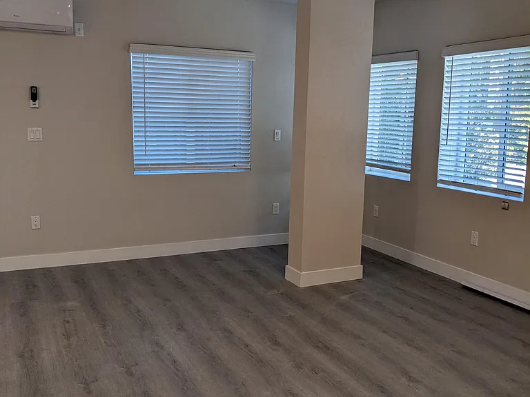 Main room with great windows and air conditioning at The Hardison Apartments in Pasadena, California.
